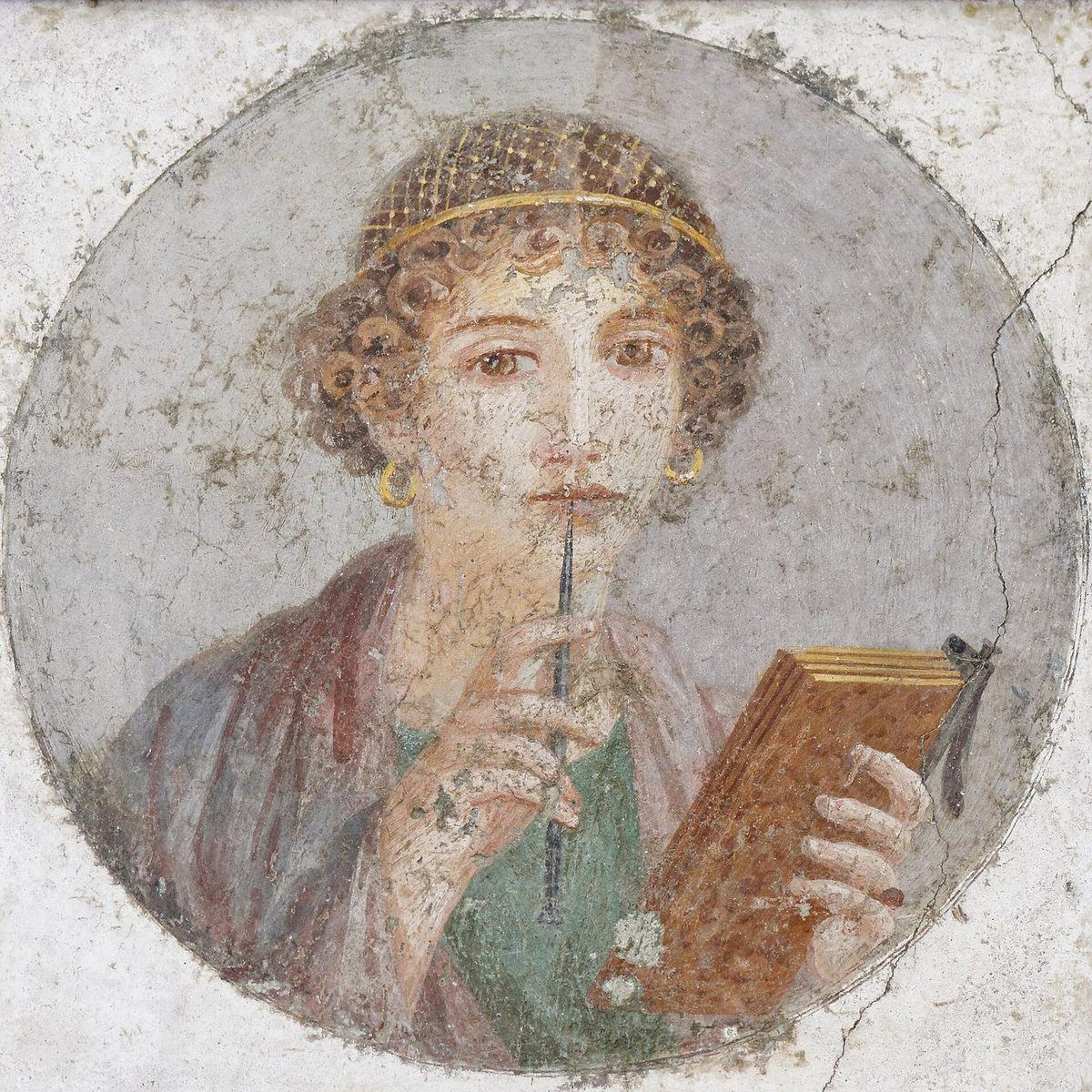A Roman fresco of a young woman with curled hair and a gold net, holding a stylus to her lips and an open wax tablet